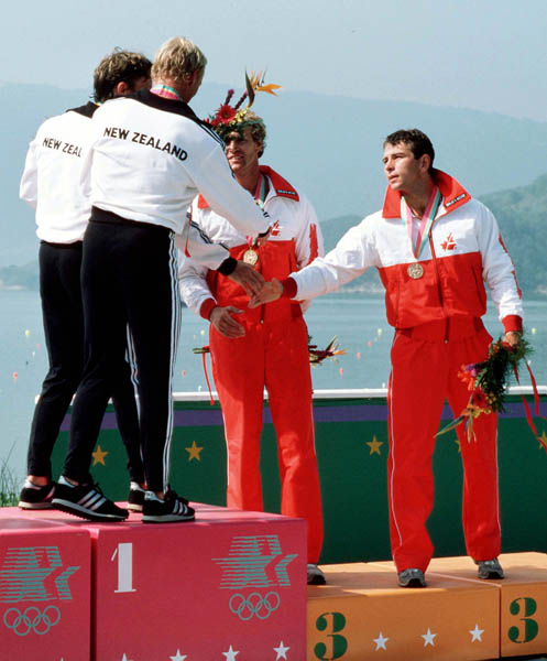 Canada's Hugh Fisher (centre) and Alwyn Morris (right) celebrate a bronze medal win in the men's kayak K-2 event at the 1984 Olympic games in Los Angeles. (CP PHOTO/ COA/)