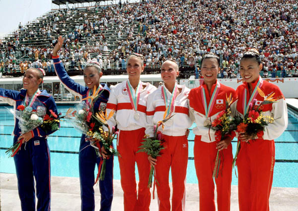 Canada's Kelly Kryczka and Sharon Hambrook (middle) celebrate a silver medal win in the synchronized swimming event at the 1984 Olympic games in Los Angeles. (CP PHOTO/ COA/Tim O'lett)