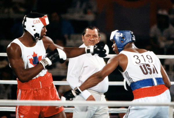 Canada's Lennox Lewis (left) competes in the boxing event at the 1984 Olympic games in Los Angeles. (CP PHOTO/ COA/ Tim O'lett)