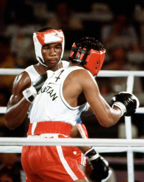 Canada's Lennox Lewis (left) competes in the boxing event at the 1984 Olympic games in Los Angeles. (CP PHOTO/ COA/ Tim O'lett)