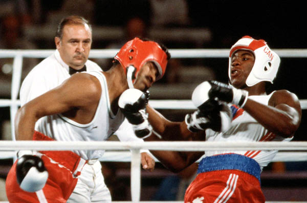 Canada's Lennox Lewis (right) competes in the boxing event at the 1984 Olympic games in Los Angeles. (CP PHOTO/ COA/ Tim O'lett)