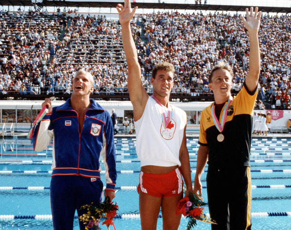 Canada's Victor Davis (centre) celebrates a silver medal win in the men's swimming event at the 1984 Olympic games in Los Angeles. (CP PHOTO/ COA/)