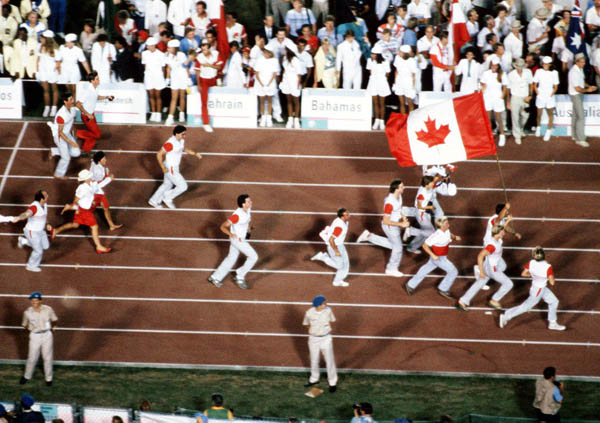 Canadian athletes run with their flag during the closing ceremonies of the 1984 Olympic games in Los Angeles. (CP PHOTO/ COA/ Tim O'lett)