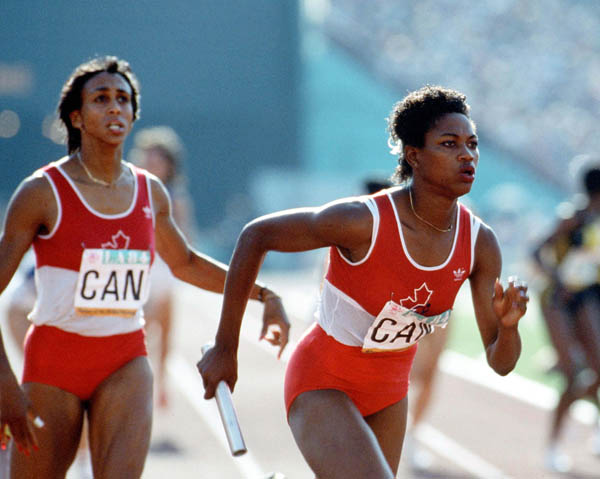 Canada's Charmaine Crooks (left) and Jillian Richardson compete in relay race at the 1984 Olympic games in Los Angeles. (CP PHOTO/ COA/JM)