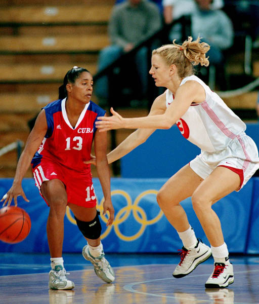 Canada's Kelly Boucher (right) covers a Cuban player during a basketball game at the Sydney 2000 Olympic Games. (CP PHOTO/ COA)