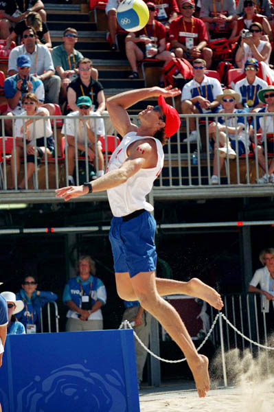 Canada's  Conrad Leinemann jumps for his serve in the beach volleyball event at the 2000 Sydney Olympic Games on September 22, 2000. (CP Photo/ COA)