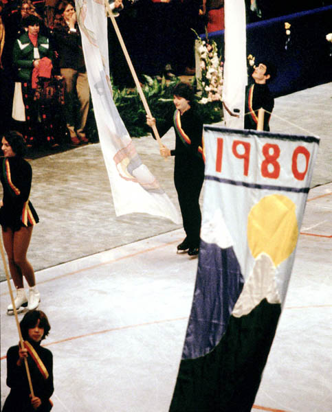 Skaters hold up banners during the closing ceremonies at the 1980 Winter Olympics in Lake Placid. (CP Photo/COA)