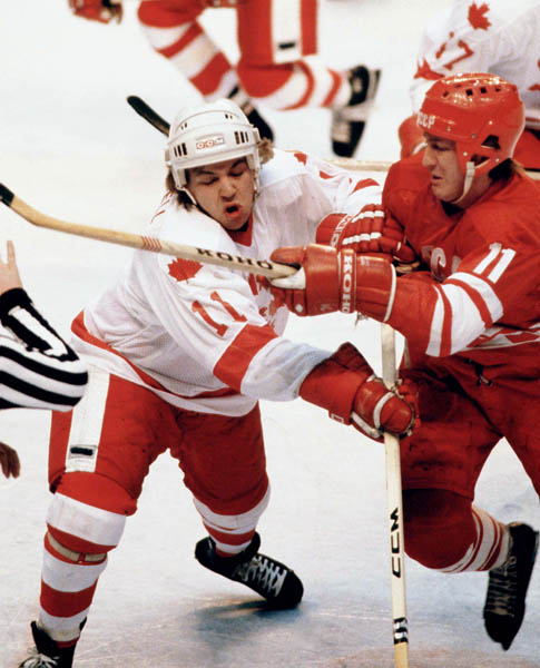 Canada's Kevin Maxwell (left) fights for position with Yuri Lebedev of the Soviet Union in hockey action against the U.S.S.R. at the 1980 Winter Olympics in Lake Placid. (CP Photo/ COA)
