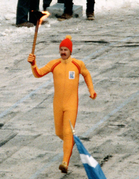 A torch bearer brings the flame during the opening ceremonies of the 1980 Winter Olympics in Lake Placid. (CP PHOTO/COA)