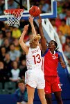 Canada's Tammy Sutton-Brown (behind) guards the basket during basketball action at the Sydney 2000 Olympic Games. (CP PHOTO/ COA)