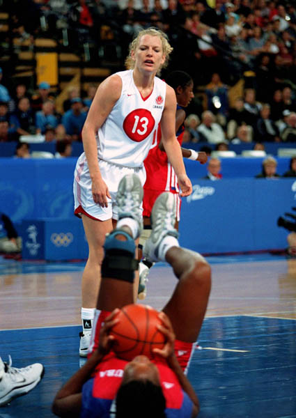 Canada's Kelly Boucher (13) looks at a fallen opponent during basketball action at the Sydney 2000 Olympic Games. (CP PHOTO/ COA)