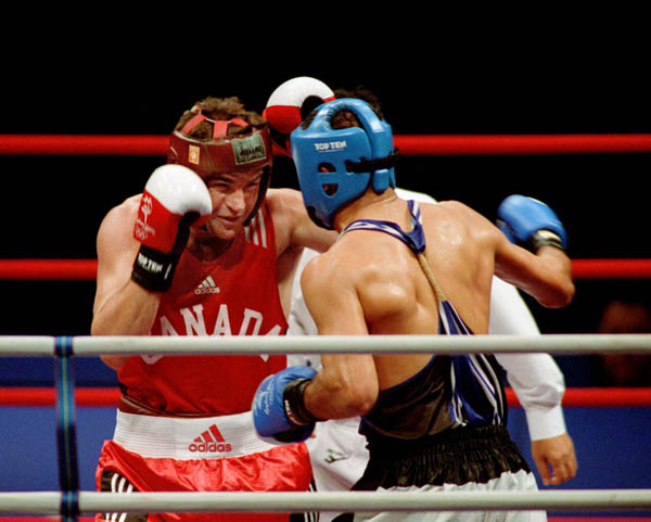 Canada's Mike Strange (left) competes in boxing action of the 2000 Sydney Olympic Games. (CP Photo/ COA)
