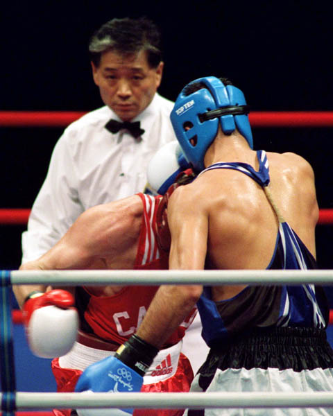 Canada's Mike Strange (red) competes in the boxing event of the 2000 Sydney Olympic Games. (CP Photo/ COA)