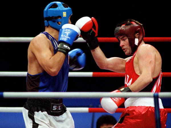 Canada's Mike Strange (right) competes in a boxing match at the 2000 Sydney Olympic Games. (CP Photo/ COA)