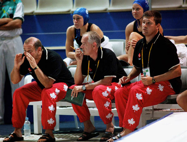 Canada's women waterpolo coach Daniel Berthelette (left)  yells encouragements at the 2000 Sydney Olympic Games. (CP Photo/COA)