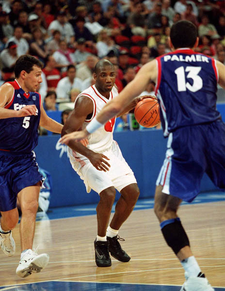Canada's Rowan Barrett (centre) run up the court during basketball action at the 2000 Sydney Olympic Games. (CP Photo/ COA)