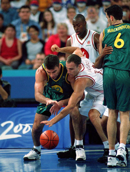 Canada's Pete Guarasci and Michael Meeks (top centre) play basketball at the 2000 Sydney Olympic Games. (CP Photo/ COA)