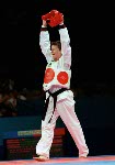 Dominique Bosshart du Canada ( gauche) assiste par son entraneur Joo Won Kang participe  une preuve de taekwondo aux Jeux olympiques de Sydney 2000. (PC-Photo/AOC)