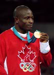 Canada's Daniel Igali celebrates his gold medal win in the wrestling event at the 2000 Sydney Olympic Games. (CP PHOTO/ COA)