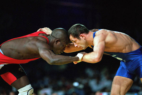 Canada's Daniel Igali (red) competes in the wrestling event at the 2000 Sydney Olympic Games. (CP Photo/ COA)