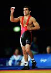 Canada's Danial Igali holds his hands up high during the medal ceremony for wrestling at the Sydney 2000 Olympic Games. (CP PHOTO/ COA)