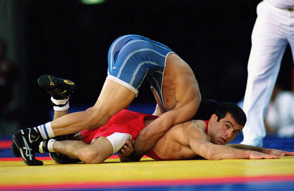 Canada's Guivi Sissaouri (red) competes in the wrestling event at the 2000 Sydney Olympic Games. (CP Photo/ COA)