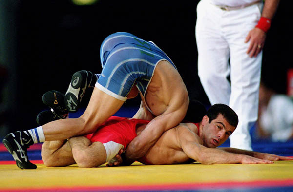 Canada's Guivi Sissaouri (red) competes in the wrestling event at the 2000 Sydney Olympic Games. (CP Photo/ COA)