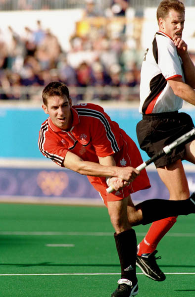 Canada's Andrew Griffiths (left) plays field hockey at the 2000 Sydney Olympic Games. (CP Photo/ COA)