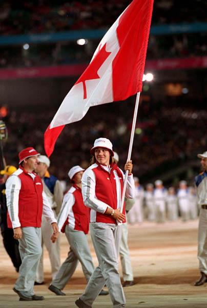 Canada's Caroline Brunet carries the Canadian flag during the opening ceremonies at the 2000 Sydney Olympic Games. (CP PHOTO/ COA)