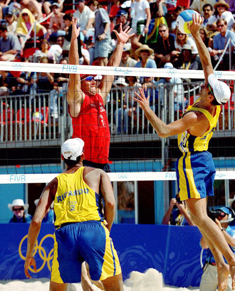 Canada's John Child (red) plays a set of beach volleyball at the 2000 Sydney Olympic Games. (CP Photo/ COA)