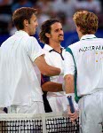 Frederic Niemeyer (foreground) of Campbellton, N.B. and Daniel Nestor of Willowdale, Ont. return the ball during their win over Slovakia in the first round of doubles tennis at the Athens Olympics, Sunday, August 15, 2004.  (CP PHOTO/COC-Mike Ridewood)
