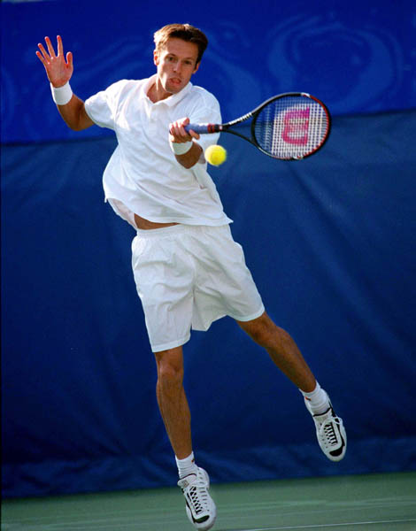Canada's Daniel Nestor returns a ball during doubles tennis action at the 2000 Sydney Olympic Games. (Mike Ridewood/CP Photo/ COA)