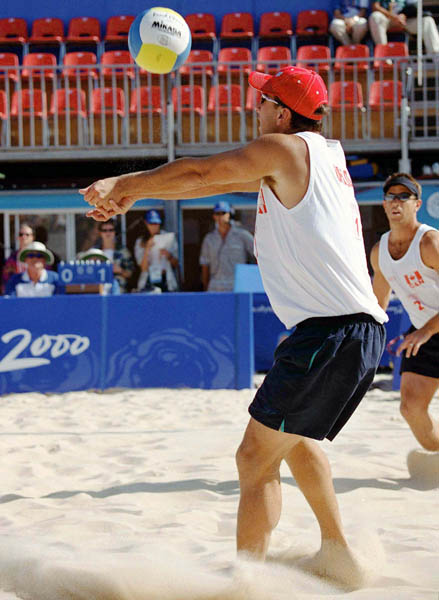 Canada's John Child (left) and Mark Heese (right) play a set of beach volleyball at the 2000 Sydney Olympic Games. (CP Photo/ COA)