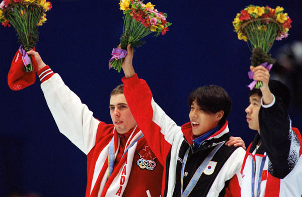 Canada's Eric Bedard (left) celebrates after winning the bronze medal in the short track speed skating event at the 1998 Nagano Olympic Games. (CP Photo/ COA)