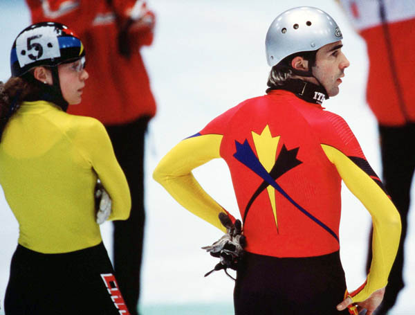 Canada's Christine Boudrias (left) and Francois Drolet  watch the action during the short track speed skating event at the 1998 Nagano Winter Olympic Games. (CP Photo/ COA/ Scott Grant)