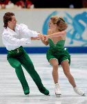 Canadians Shae-Lynn Bourne and Victor Kraatz are all smiles as they skate during their Ice Dancing Original Dance at the 2002 Olympic Winter Games in Salt Lake City. (CP Photo/COA/Andre Forget).