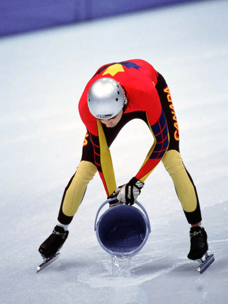 Canada's Francois Drolet fixes the ice surface between races in the short track speed skating event at the 1998 Nagano Winter Olympic Games. (CP Photo/ COA/ Scott Grant)