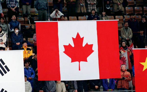 The Canadian Flag is raised for a gold medal win at the 1998 Nagano Winter Olympic Games. (CP Photo/ COA/ Scott Grant)