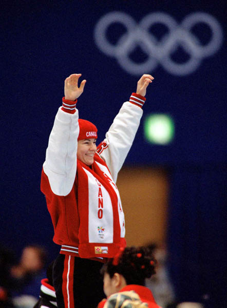 Canada's Annie Perreault celebrates after winning the gold medal in the women's short track speed skating event at the 1998 Nagano Winter Olympics. (CP PHOTO/COA/Scott Grant)