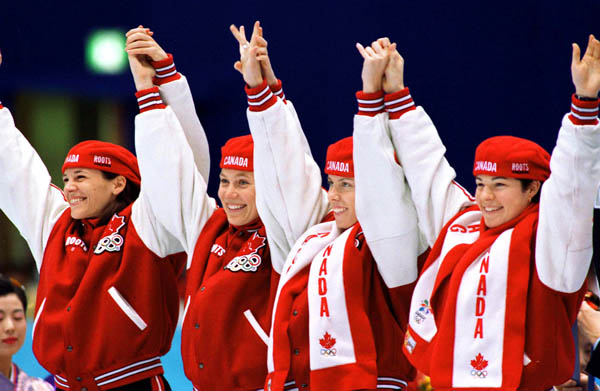 Canada's women's relay team (left to right) Isabelle Charest, Christine Boudrias, Tania Vincent and Annie Perreault celebrate after winning the bronze medal in the women's short track speed skating event at the 1998 Nagano Olympic Games . (CP Photo/ COA/S