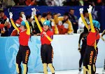 Catriona Le May Doan (centre) is congratulated by her husband Bart Doan (right) and Sabine Voelker of Germany after setting an Olympic record of 37.30 in the 500 metres speed skating race at the Winter Olympics in Salt Lake City, Wed., Feb. 13, 2002.  The