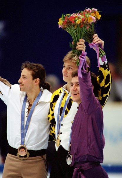 Canada's Elvis Stojko (right) celebrates after winning the silver medal in the figure skating event at the 1998 Nagano Winter Olympic Games. (CP Photo/ COA)