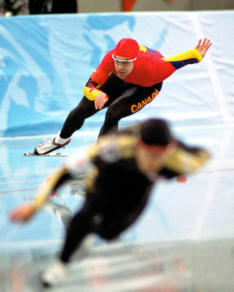 Canada's Patrick Bouchard (red) competes in the long track speed skating event at the 1998 Nagano Winter Olympic Games. (CP Photo/ COA/ Scott Grant)