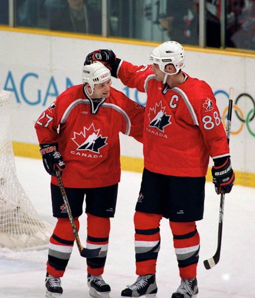 Canada's Shayne Corson (27) and Eric Lindros (88) compete in hockey action at the 1998 Winter Olympics in Nagano. (CP Photo/COA/ F. Scott Grant )