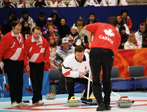 Canada's men's curling team studies the stones during a match at the 1998 Nagano Winter Olympics. (CP PHOTO/COA)