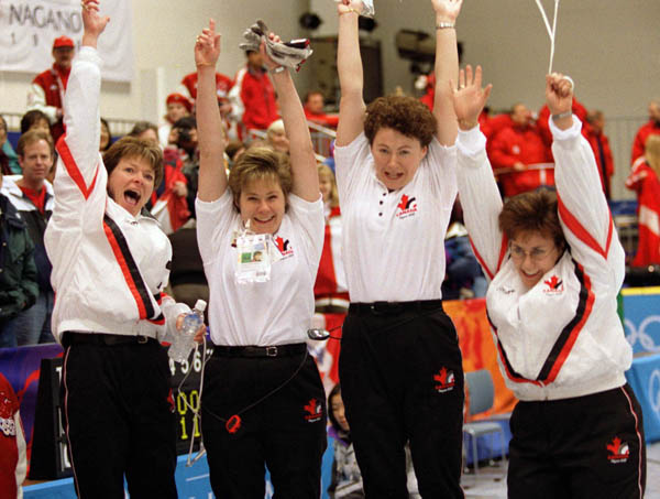 Canada's women's curling team (from left to right) Jan Betker, Marcia Gudereit, Joan McCusker and Sandra Schmirler cheer at the 1998 Nagano Winter Olympics. (CP PHOTO/COA/Mike Ridewood)
