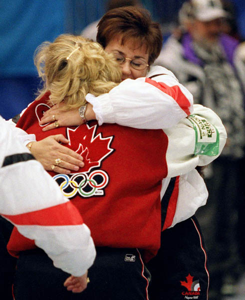 Canada's Sandra Schmirler hugs a teammate during a curling match at the 1998 Nagano Winter Olympics. (CP PHOTO/COA)