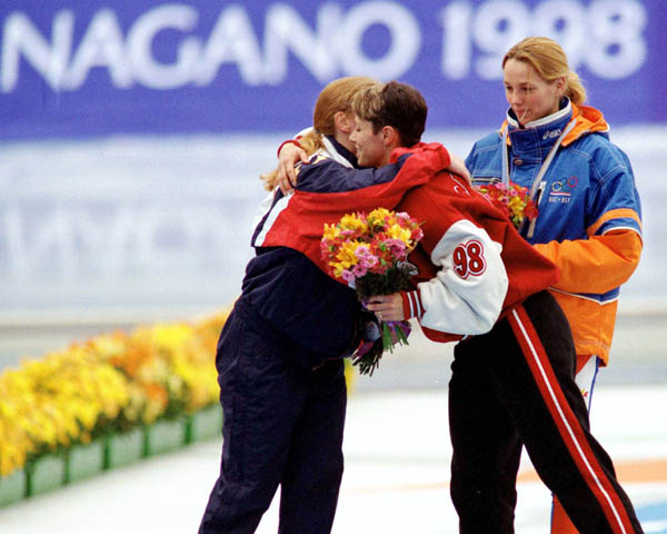 Canada's Catriona Le May Doan (centre) celebrates after winning a bronze medal in the women's long track speed skating event at the 1998 Nagano Winter Olympics. (CP PHOTO/COA/Mike Ridewood)