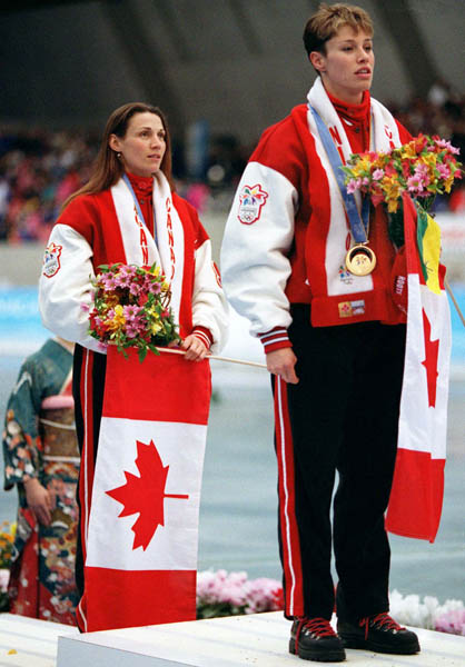 Canada's Catriona Le May Doan (right) and Susan Auch (left) celebrate their respective gold and silver medals at a long track speed skating event at the 1998 Nagano Winter Olympics. (CP PHOTO/COA/Mike Ridewood)