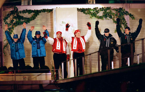 Canada's Pierre Lueders (centre left) and Dave MacEachern celebrate their gold medal win in the two-man bobsleigh event at the 1998 Nagano Winter Olympics. (CP PHOTO/COA/F. Scott Grant)